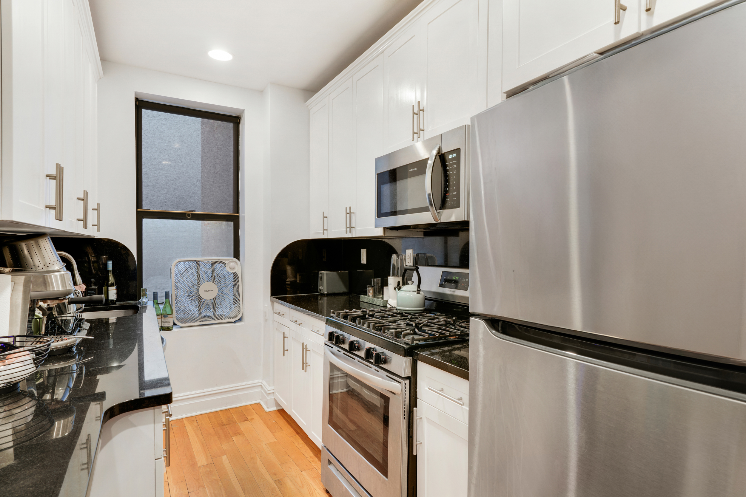 812 Riverside Drive, Unit 45 Manhattan, NY 10032 - Photo 5 of 9 a kitchen with stainless steel appliances a refrigerator stove and sink