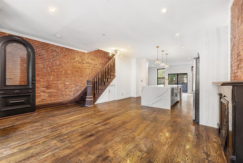 308 Clifton Place Brooklyn, NY 11216 - Photo 8 of 41 a view of a livingroom with wooden floor and stairs