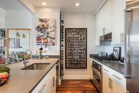 a kitchen with stainless steel appliances a sink a stove and a refrigerator