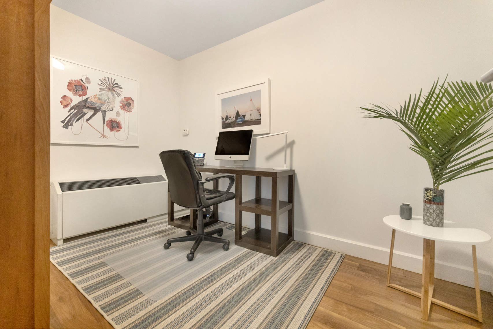 2-17 51st Avenue, Unit 606 Queens, NY 11101 - Photo 7 of 18 a view of a workspace with furniture and wooden floor