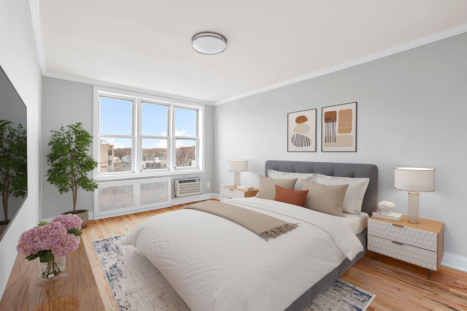 a bedroom with a bed and a large window