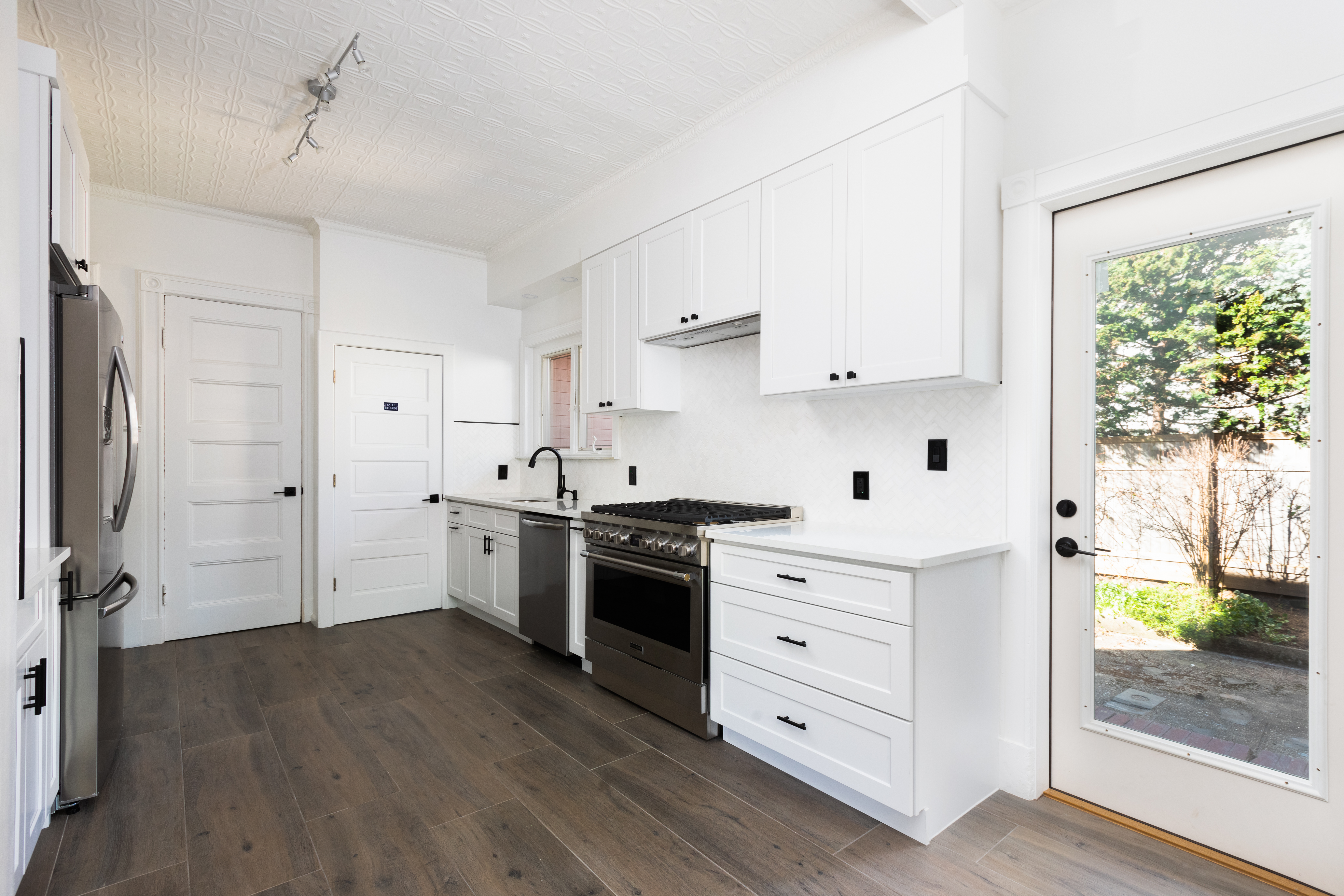 196 Marlborough Road Brooklyn, NY 11226 - Photo 13 of 23 a kitchen with white cabinets and wooden floor