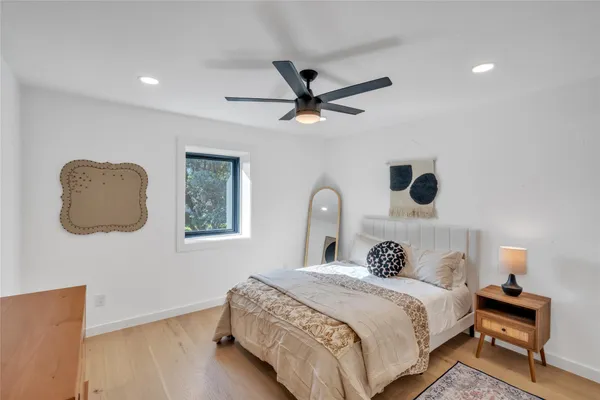 a bedroom with a bed and a window