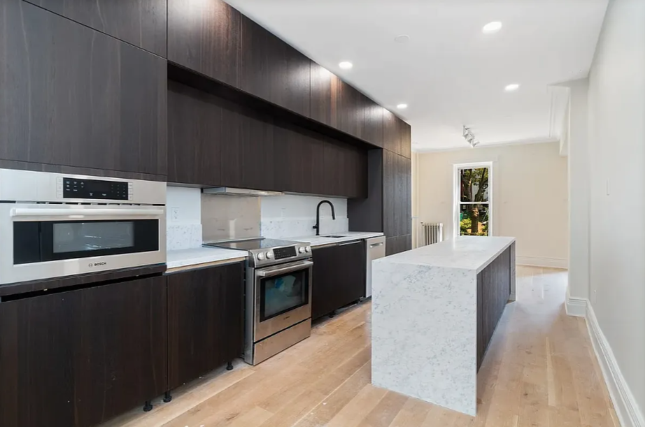 278 Macon Street, Unit 1 Brooklyn, NY 11216 - Photo 2 of 7 a large kitchen with stainless steel appliances a stove a sink and a microwave