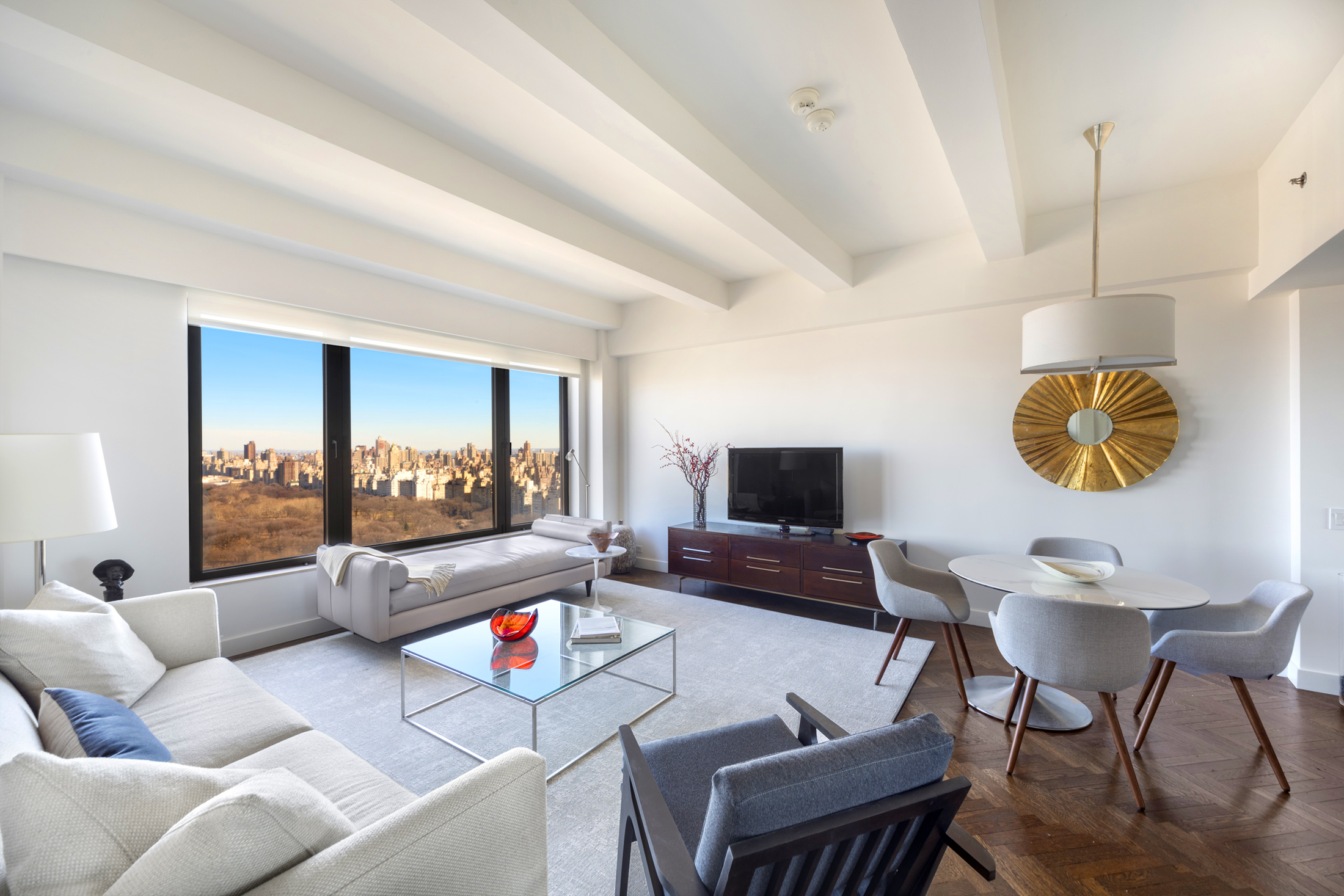 160 Central Park South, Unit 3903 Manhattan, NY 10019 - Photo 1 of 11 a living room with furniture and a flat screen tv