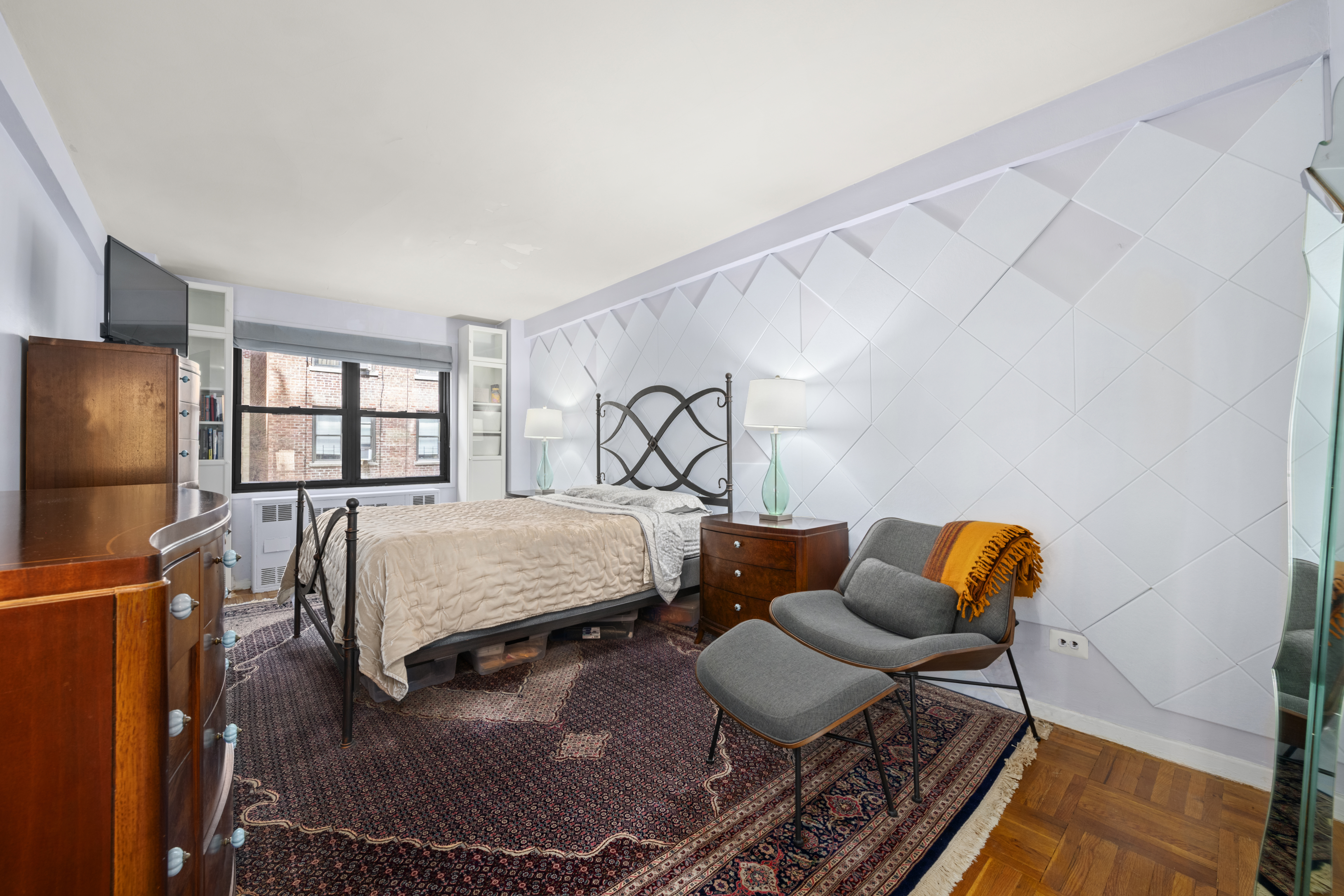 347 East 53rd Street, Unit 2B Manhattan, NY 10022 - Photo 3 of 7 a bedroom with furniture and a window