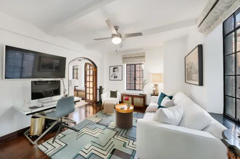 a living room with furniture fireplace and a flat screen tv