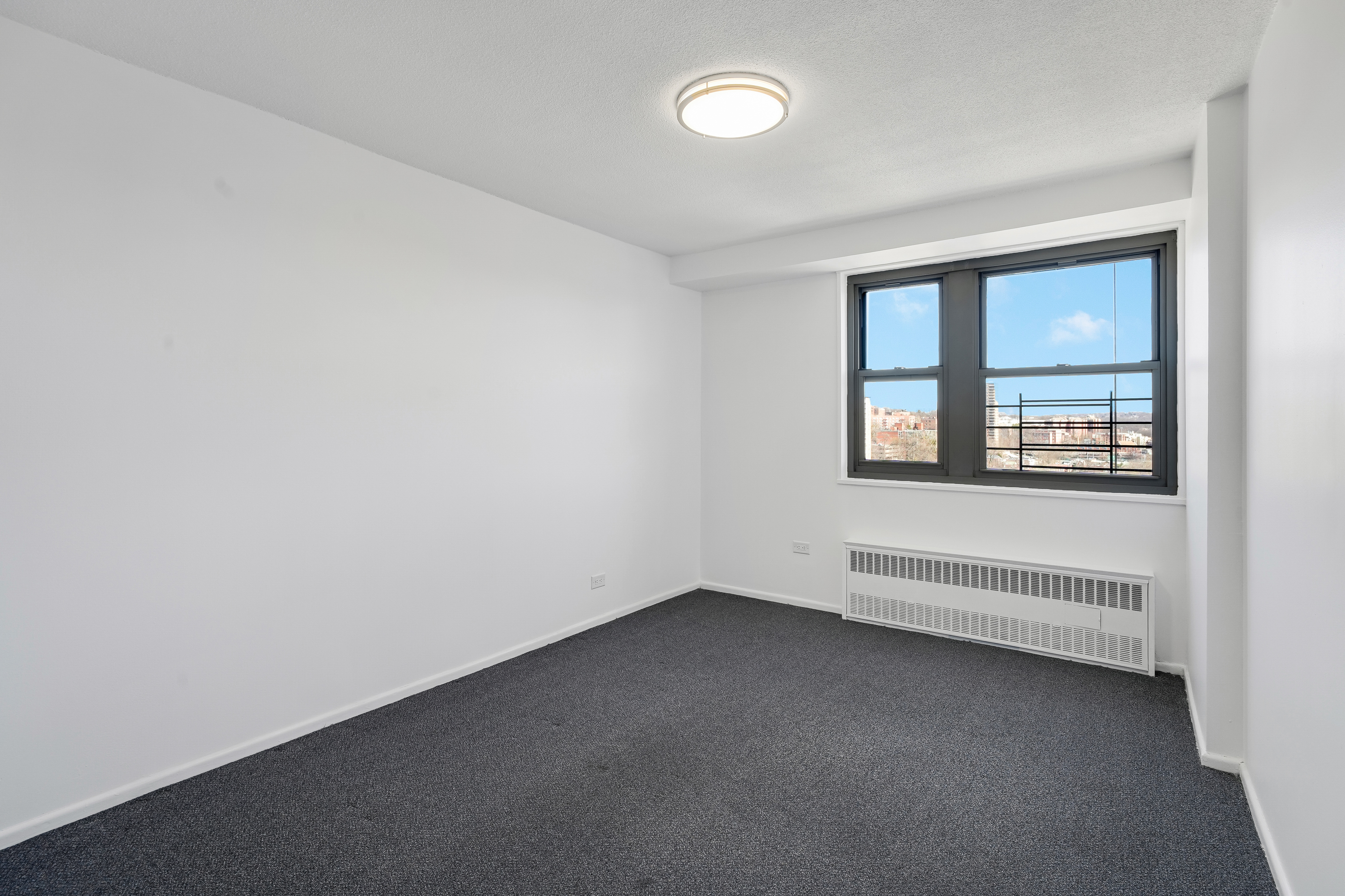 290 West 232nd Street, Unit 18B Bronx, NY 10463 - Photo 9 of 16 an empty room with a window