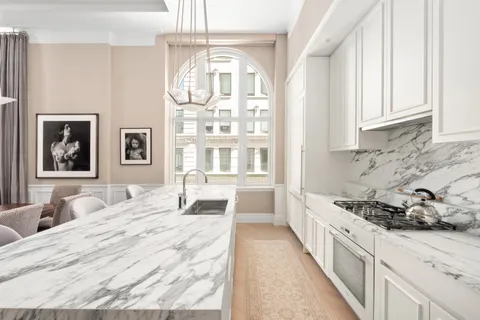 a kitchen with a sink stove and cabinets