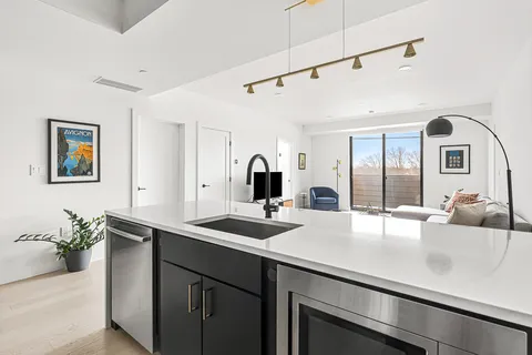 a kitchen with a sink and refrigerator