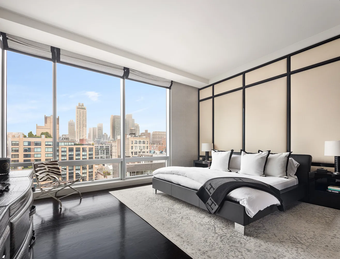 a bedroom with a large bed and a large window