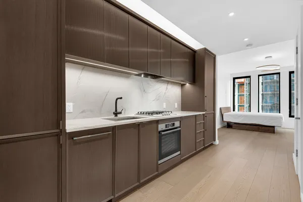 a kitchen with stainless steel appliances granite countertop a sink and a stove