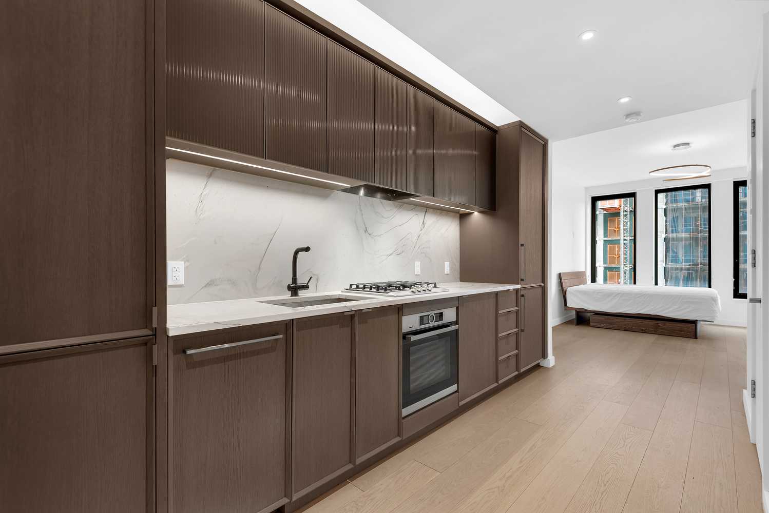 58 St Marks Place, Unit 406 Brooklyn, NY 11217 - Photo 2 of 6 a kitchen with stainless steel appliances granite countertop a sink and a stove
