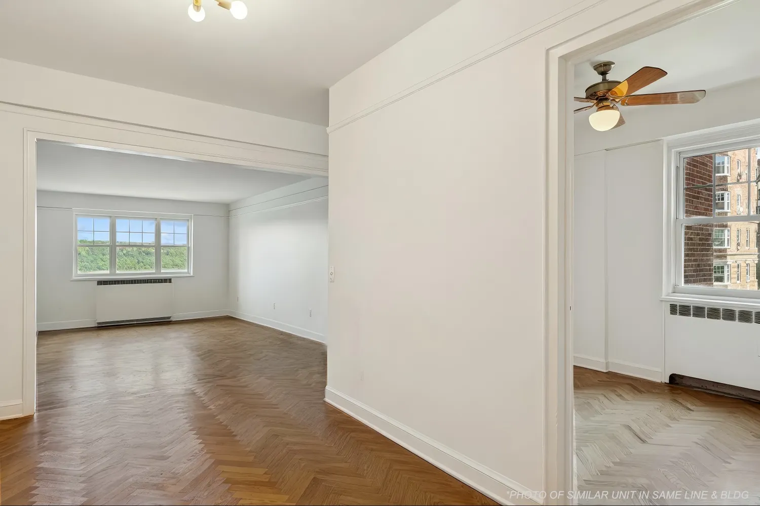 an empty room with windows and closet