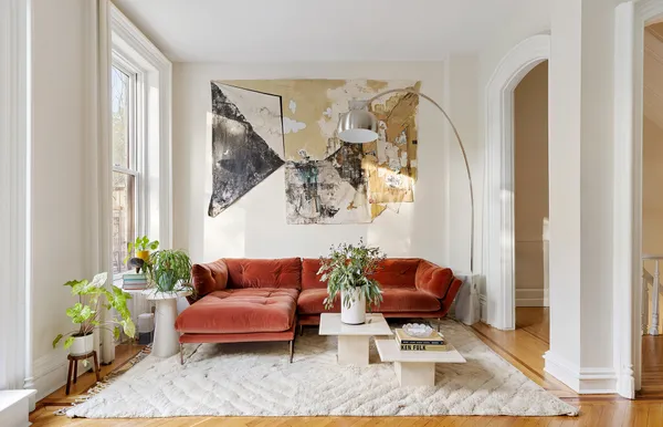 a living room with furniture and a potted plant
