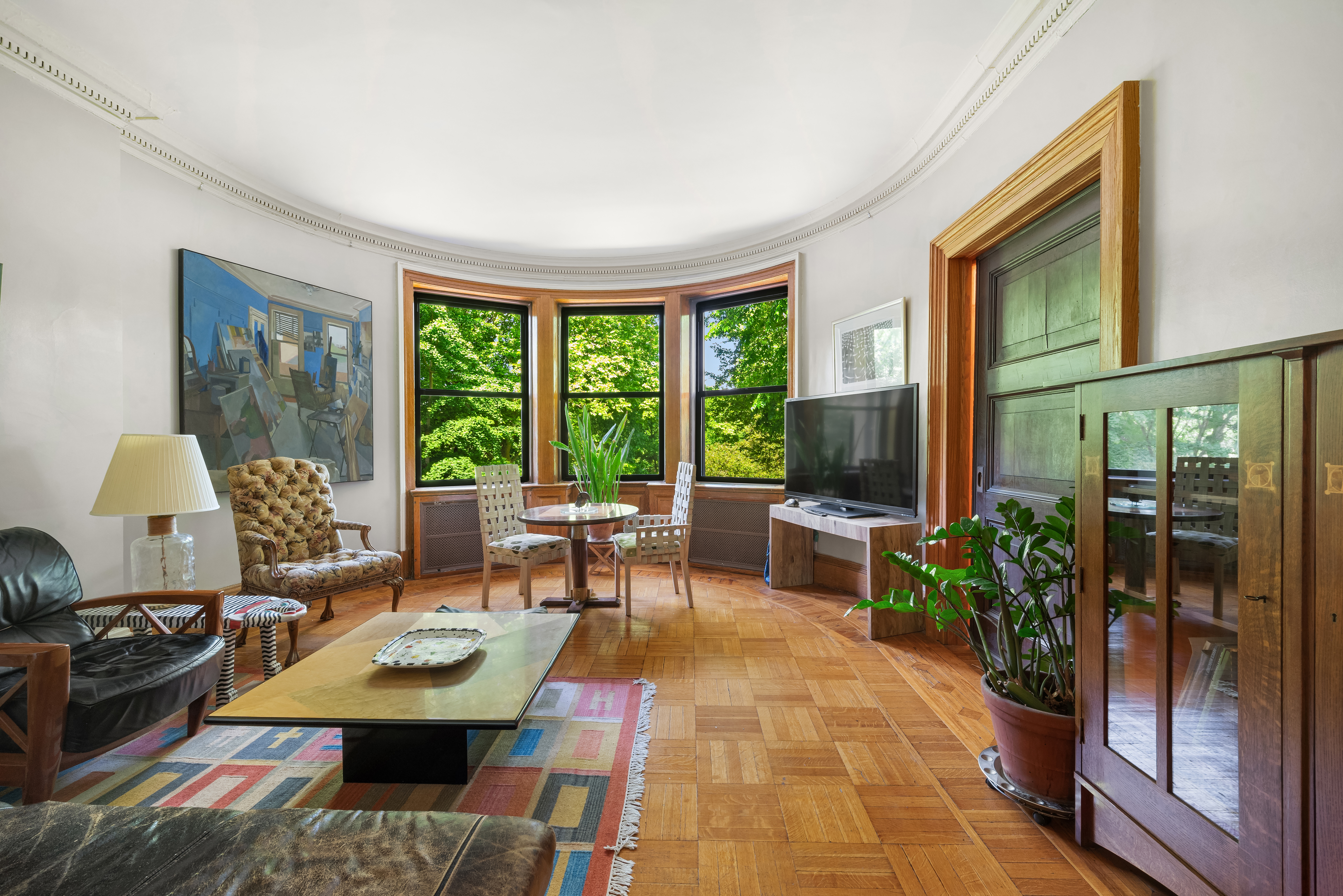 293 Riverside Drive, Unit 3A/4A Manhattan, NY 10025 - Photo 1 of 9 a living room with furniture and a large window