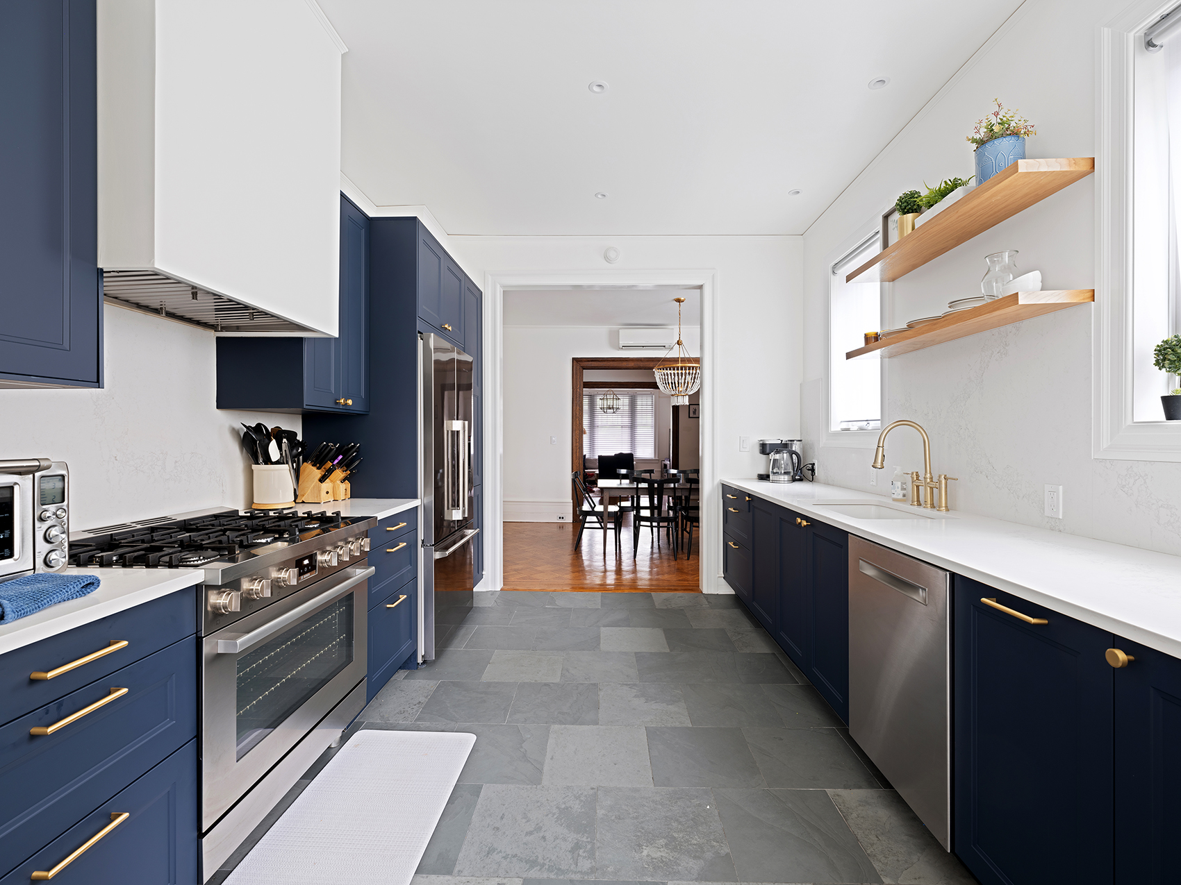 207 Windsor Place Brooklyn, NY 11215 - Photo 7 of 20 a large kitchen with stainless steel appliances granite countertop a stove a sink and a refrigerator