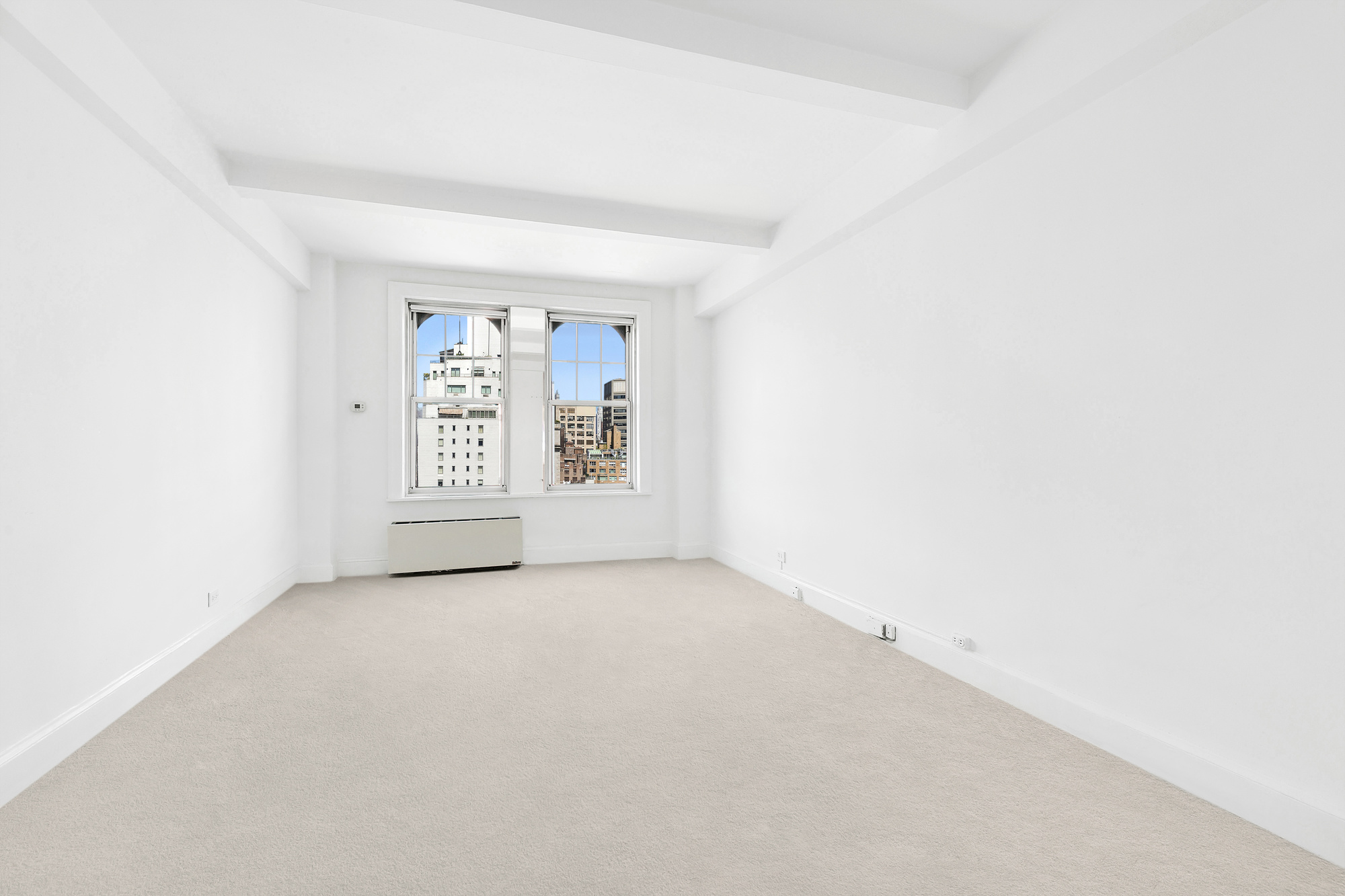 575 Park Avenue, Unit 1403 Manhattan, NY 10065 - Photo 7 of 15 an empty room with windows
