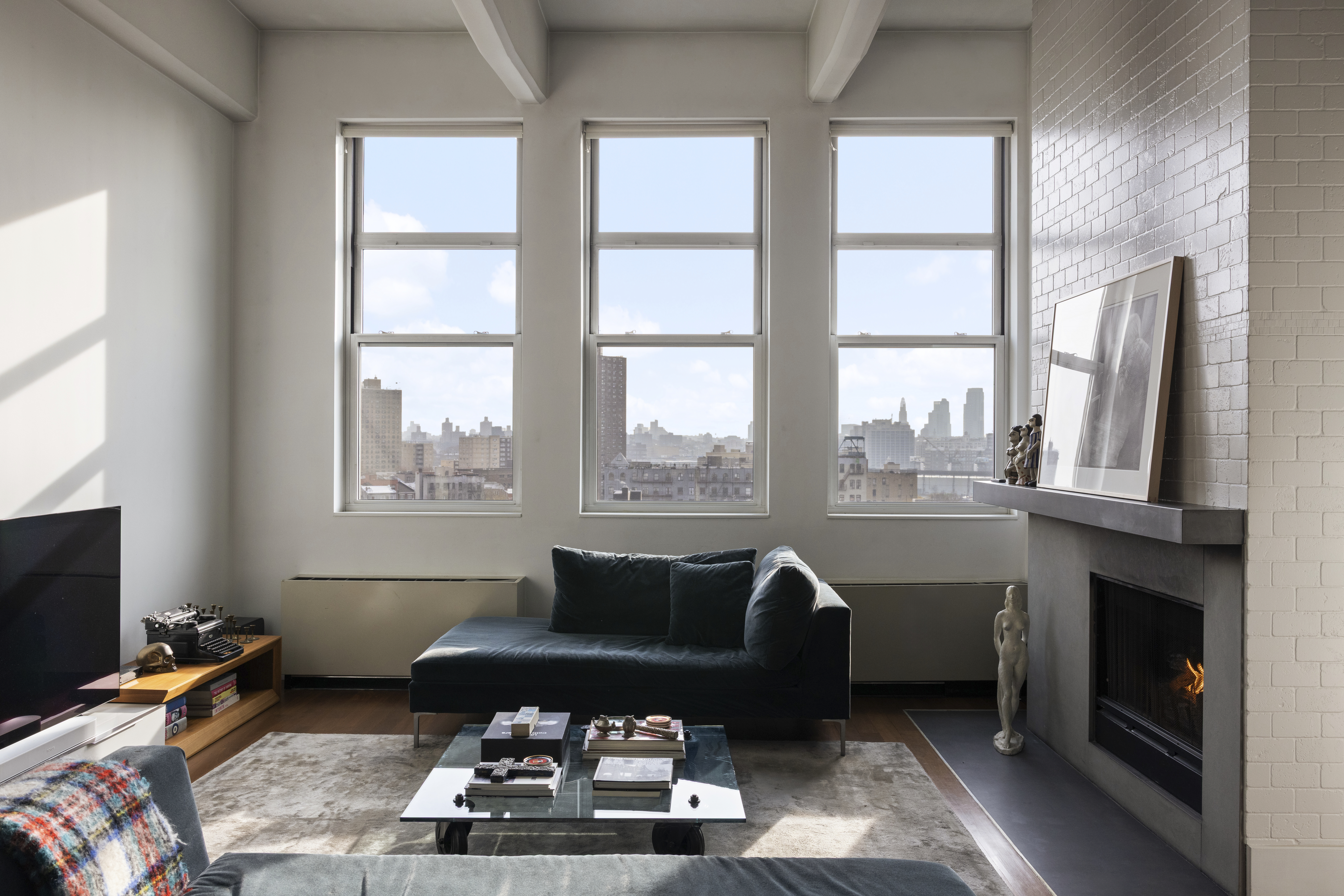 60 Broadway, Unit 8K Brooklyn, NY 11249 - Photo 2 of 10 a living room with furniture and a flat screen tv