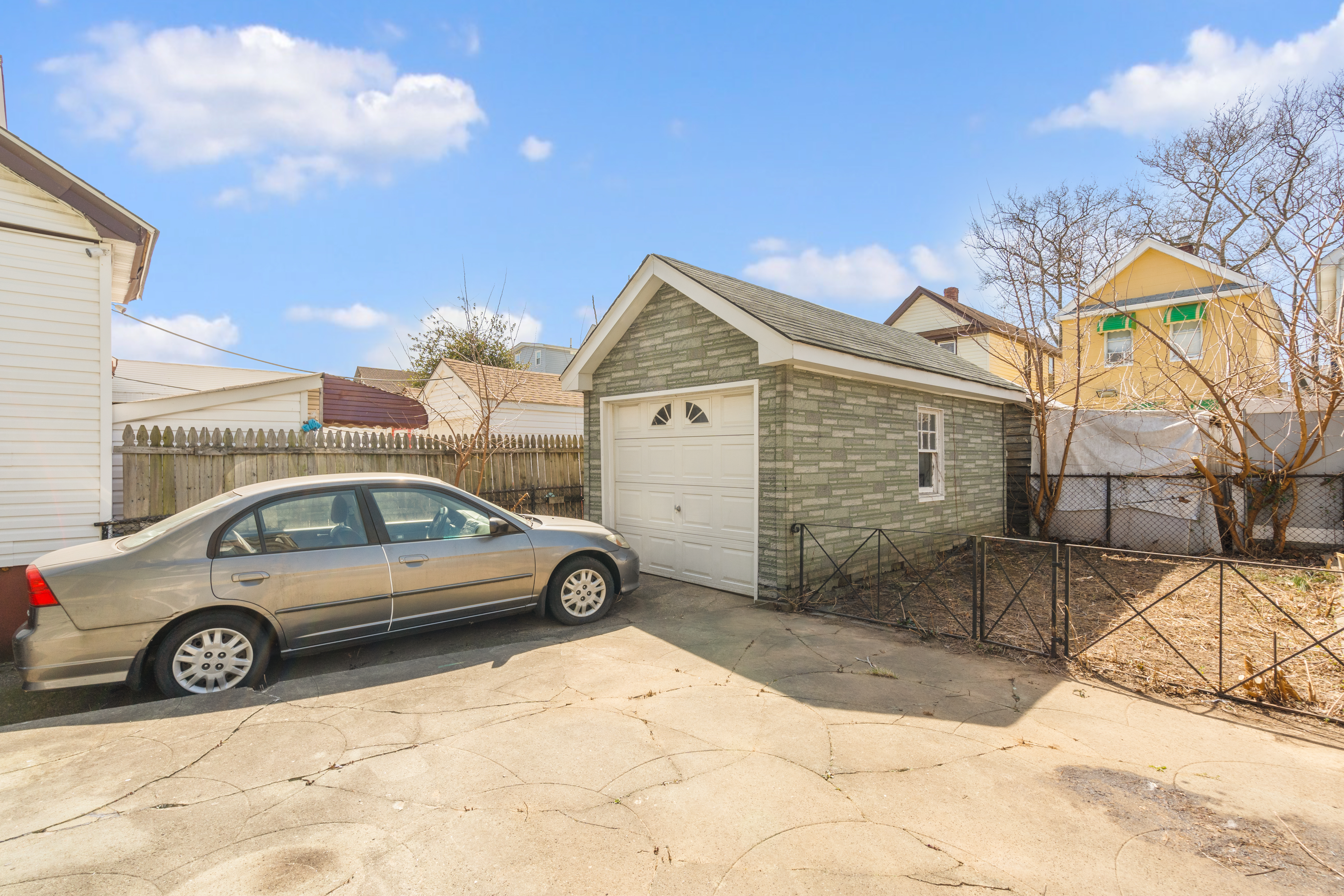 107-28 118th Street Queens, NY 11419 - Photo 11 of 12 a view of a car parked in front of a house