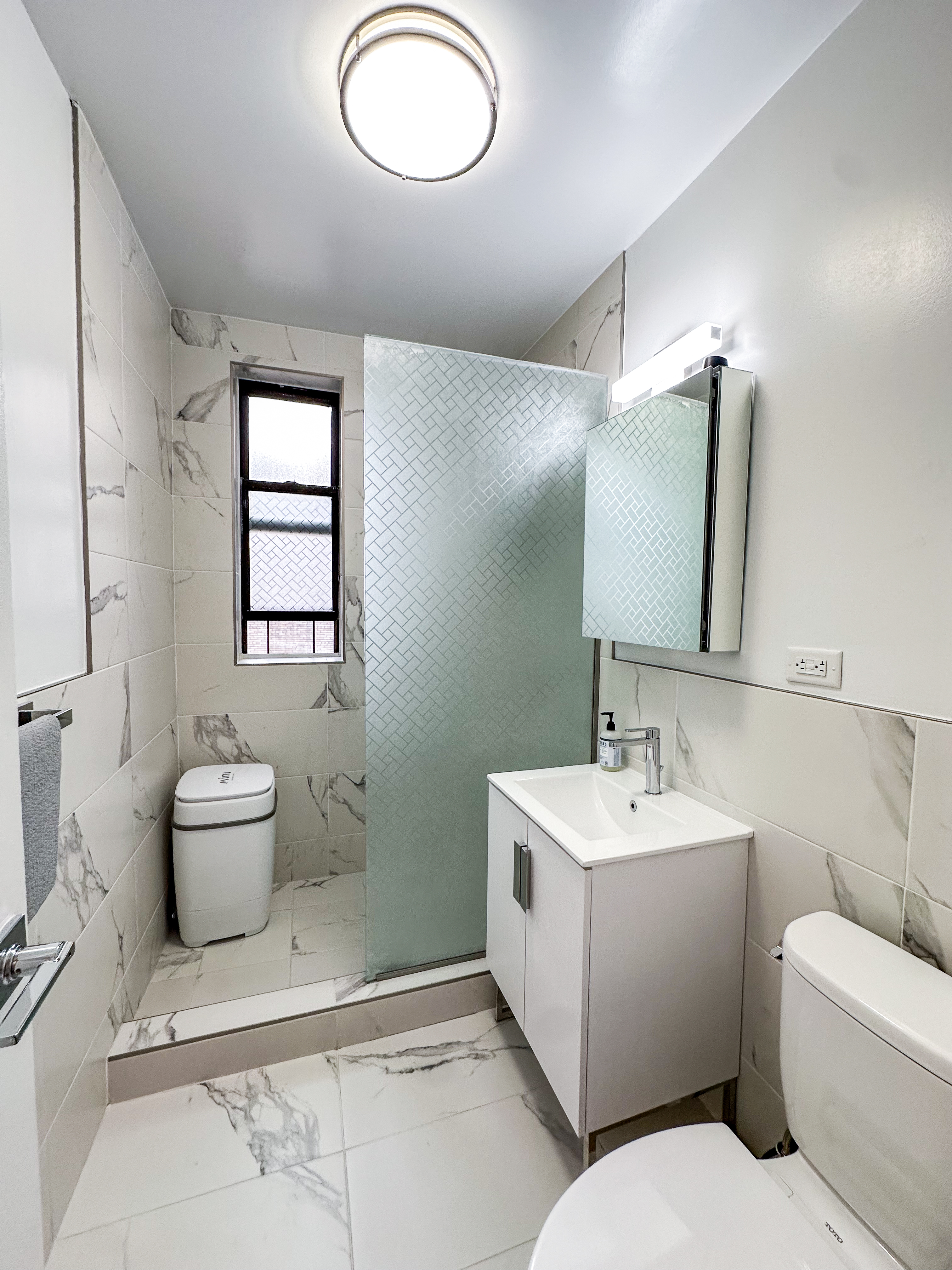 2420 Morris Avenue, Unit 6B Bronx, NY 10468 - Photo 16 of 16 a bathroom with a toilet sink and mirror