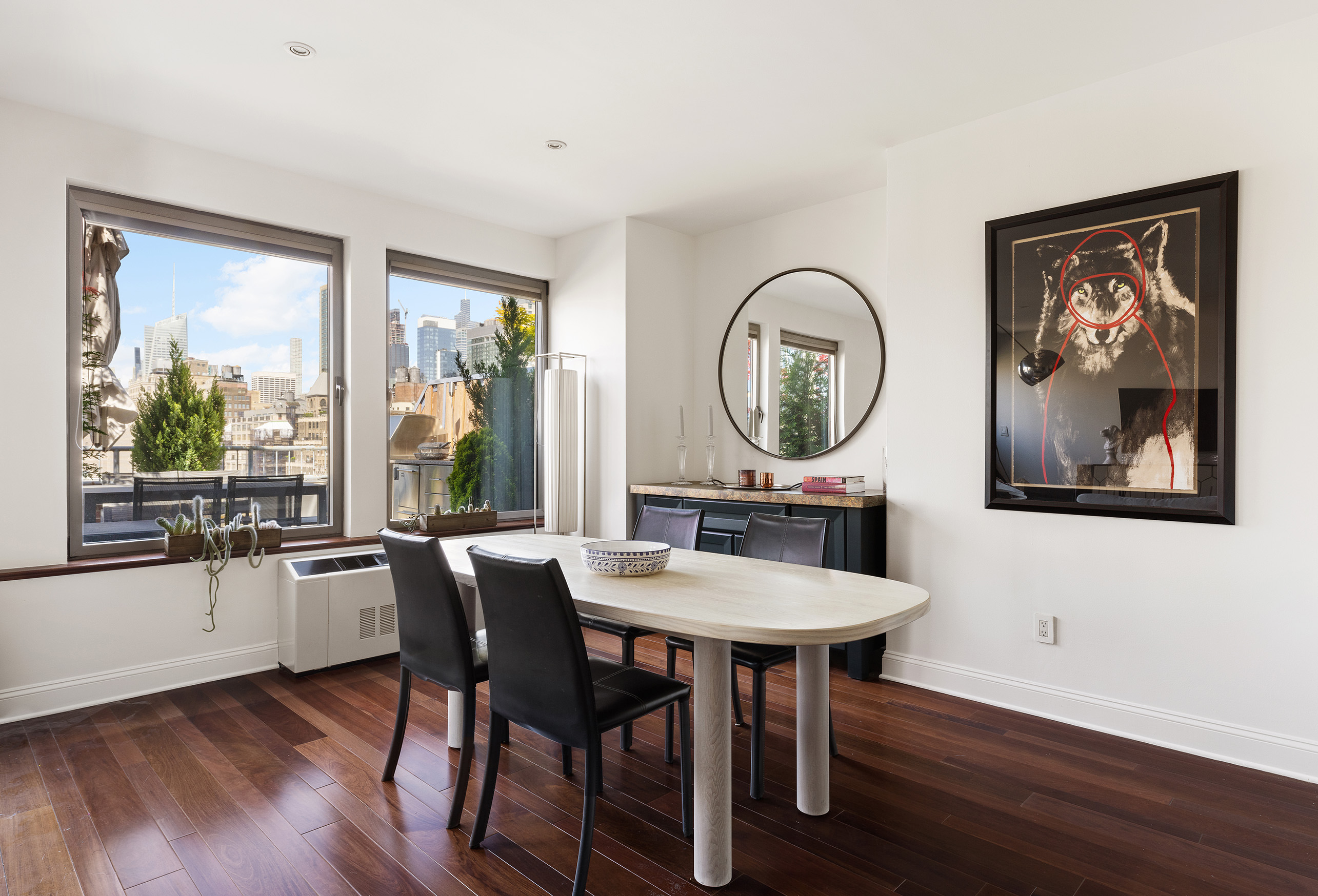 252 7th Avenue, Unit PHG Manhattan, NY 10001 - Photo 9 of 27 a living room with furniture a wooden floor and a large window