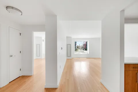 a view of a room with wooden floor and window