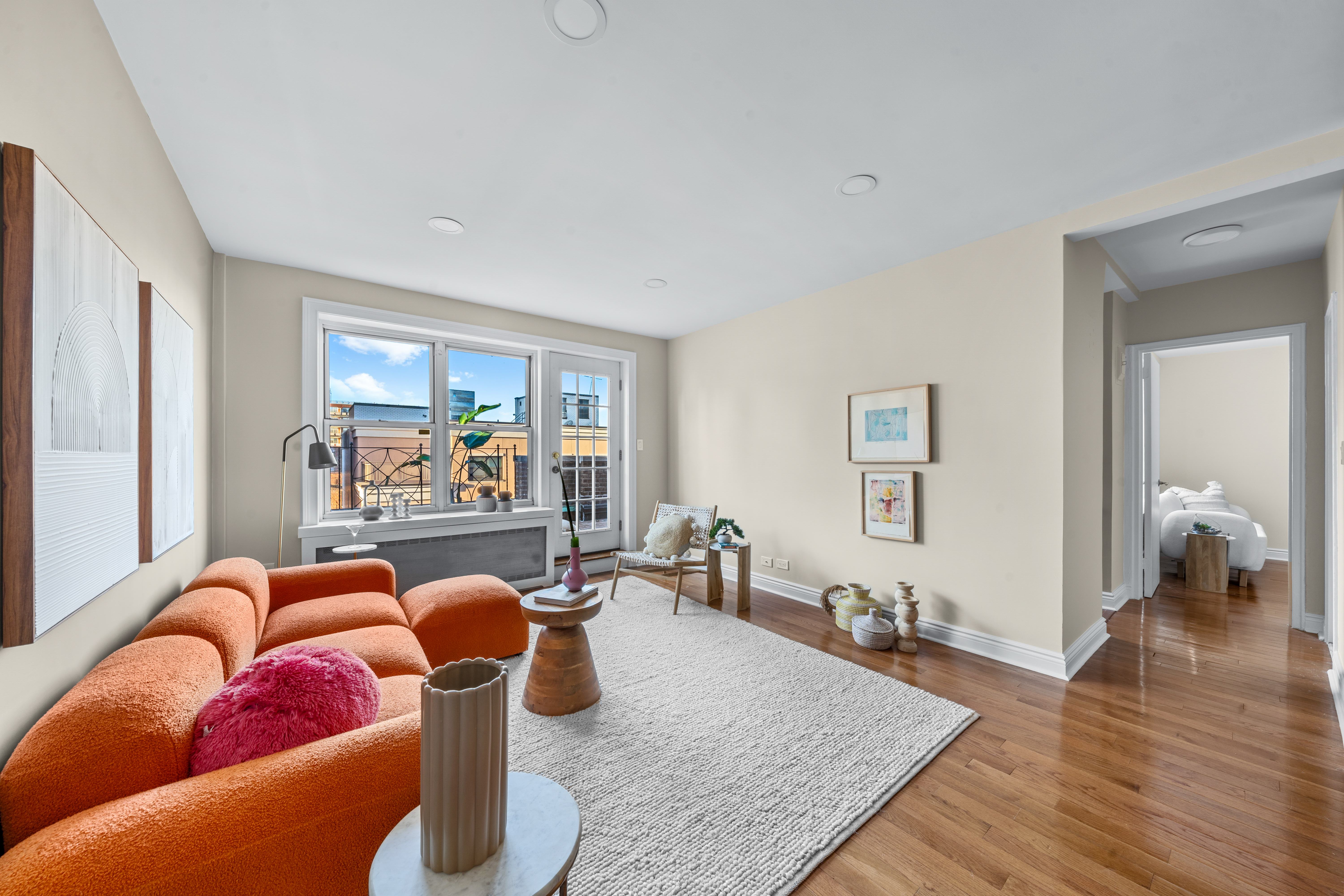 71-36 110th Street, Unit PH7E Queens, NY 11375 - Photo 2 of 16 a living room filled with furniture and a wooden floor