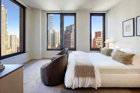a bedroom with a bed and glass windows