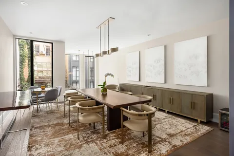 a living room filled with furniture and a chandelier
