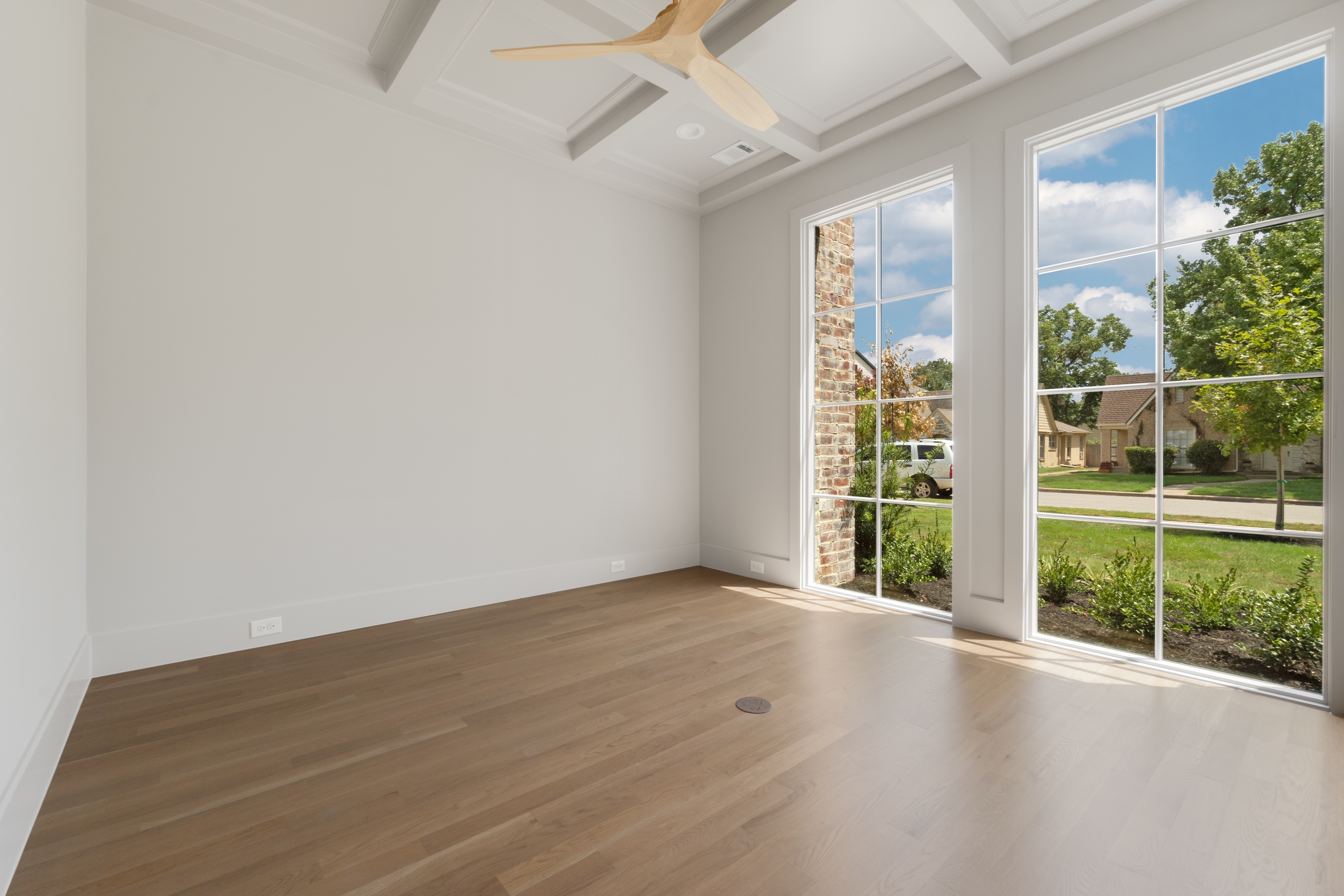 4410 Glenwick Lane Dallas, TX 75205 - Photo 19 of 28 an empty room with wooden floor and windows