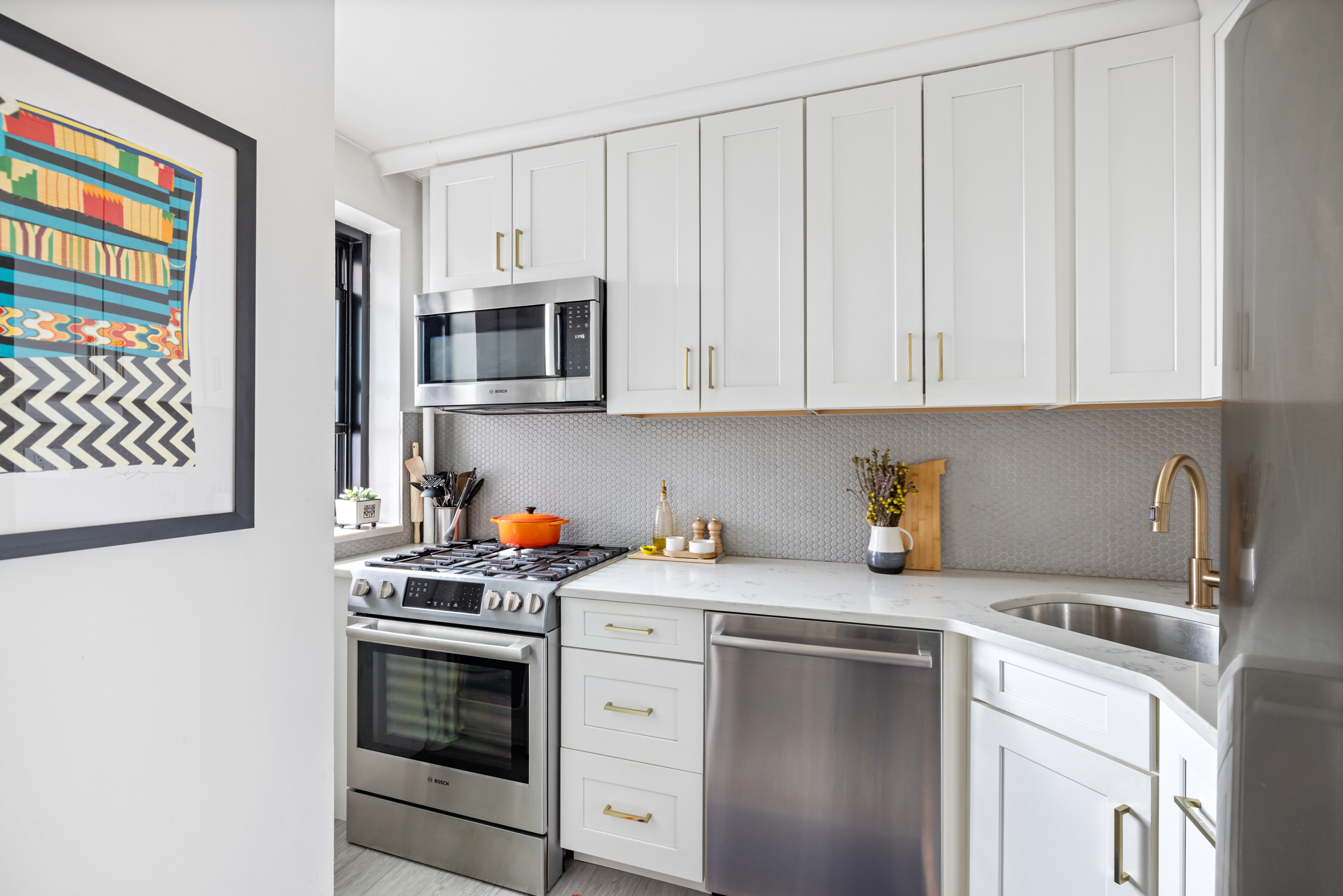 325 Clinton Avenue, Unit 7A Brooklyn, NY 11205 - Photo 5 of 13 a kitchen with stainless steel appliances white cabinets and a stove top oven