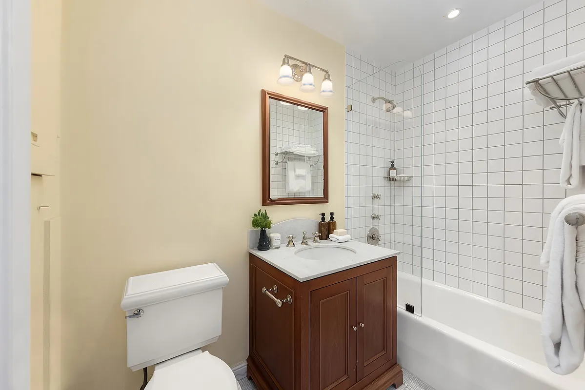 180 East 79th Street, Unit 14B Manhattan, NY 10075 - Photo 17 of 18 a bathroom with a sink a toilet and shower