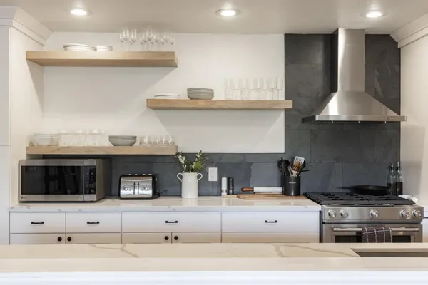 a kitchen with a stove and a white cabinets