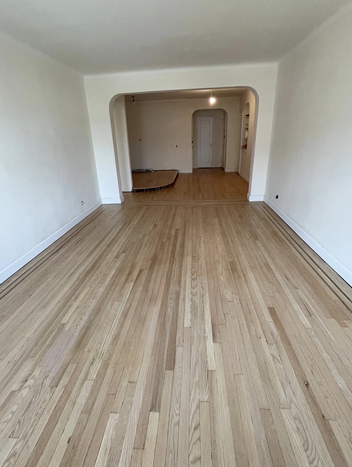 69-40 Yellowstone Boulevard, Unit 510 Queens, NY 11375 - Photo 7 of 11 a view of an empty room with wooden floor and a window