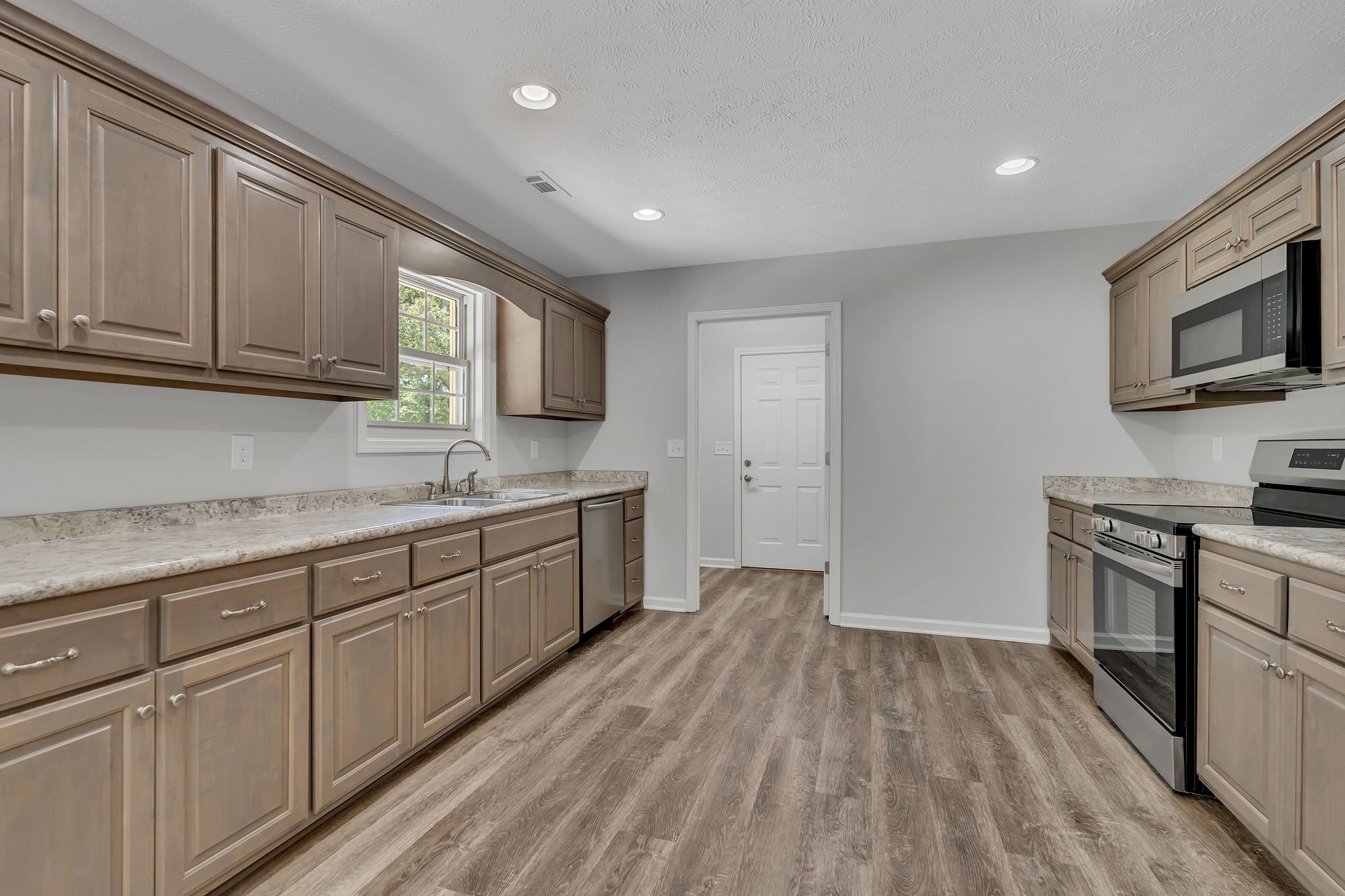 543 Paynes Church Road Estill Springs, TN 37330 - Photo 14 of 33 a kitchen with granite countertop cabinets stainless steel appliances a sink and wooden floor
