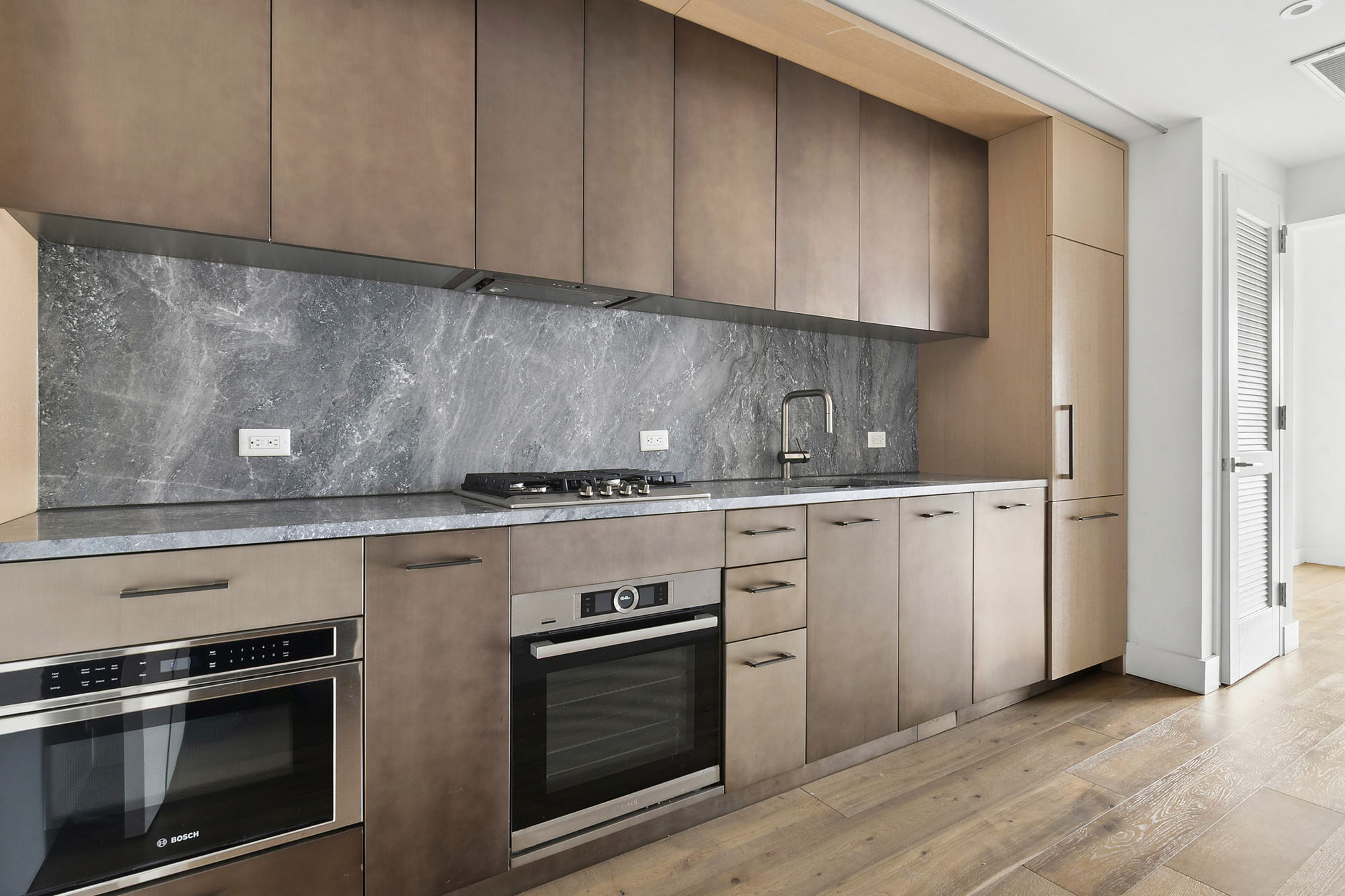 561 Pacific Street, Unit 404 Brooklyn, NY 11217 - Photo 3 of 10 a kitchen with granite countertop white cabinets and stainless steel appliances