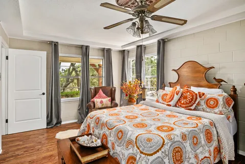 a bedroom with a bed and wooden floor