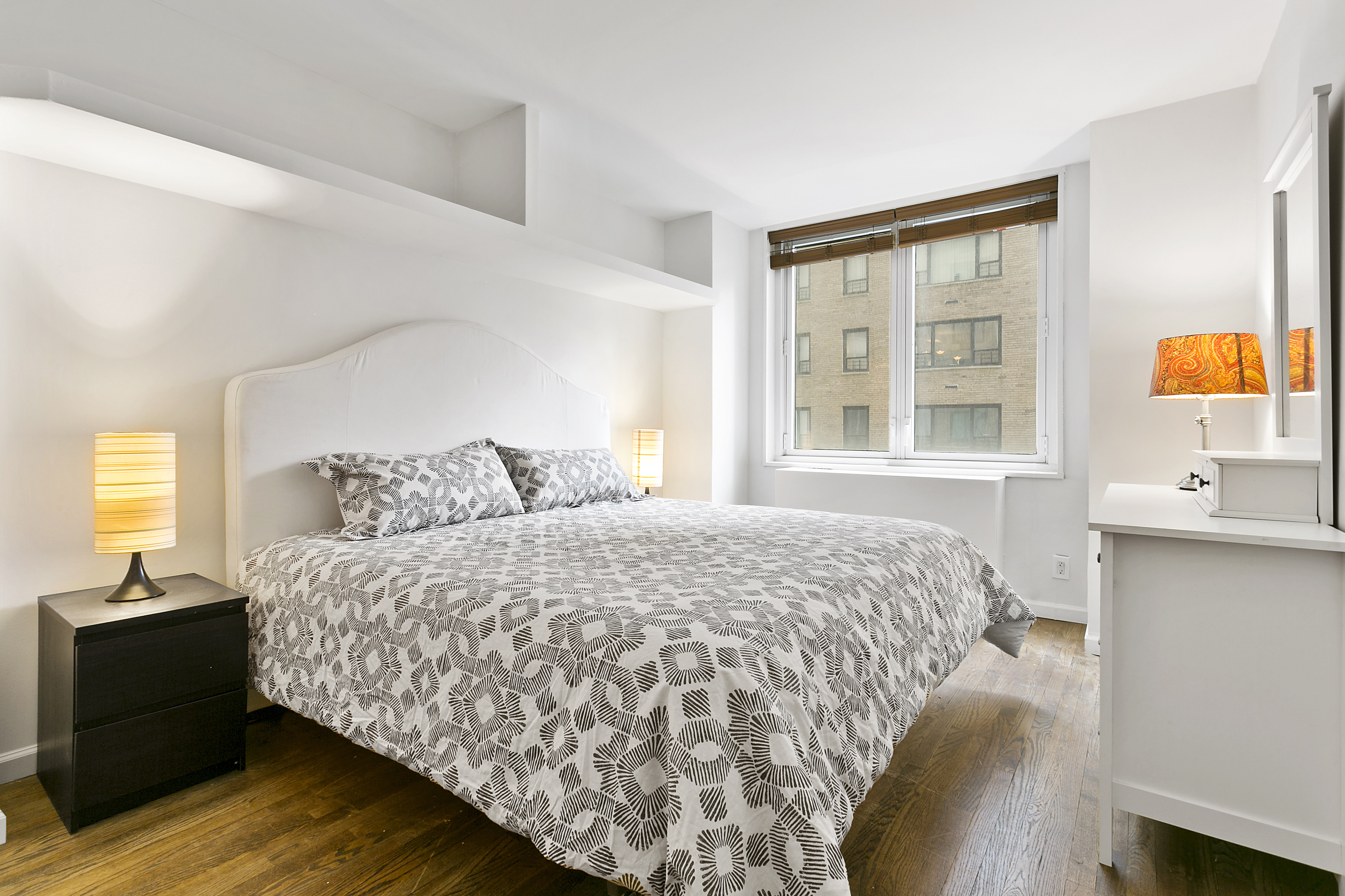 212 East 47th Street, Unit 6B Manhattan, NY 10017 - Photo 3 of 11 a bedroom with a bed and window