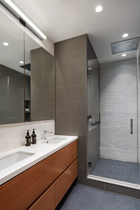 40 West 17th Street, Unit 9A Manhattan, NY 10011 - Photo 8 of 12 a bathroom with a sink a shower and a mirror