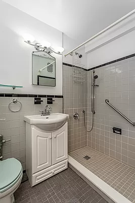 221 East 50th Street, Unit 8B Manhattan, NY 10022 - Photo 8 of 9 a bathroom with a sink toilet and shower
