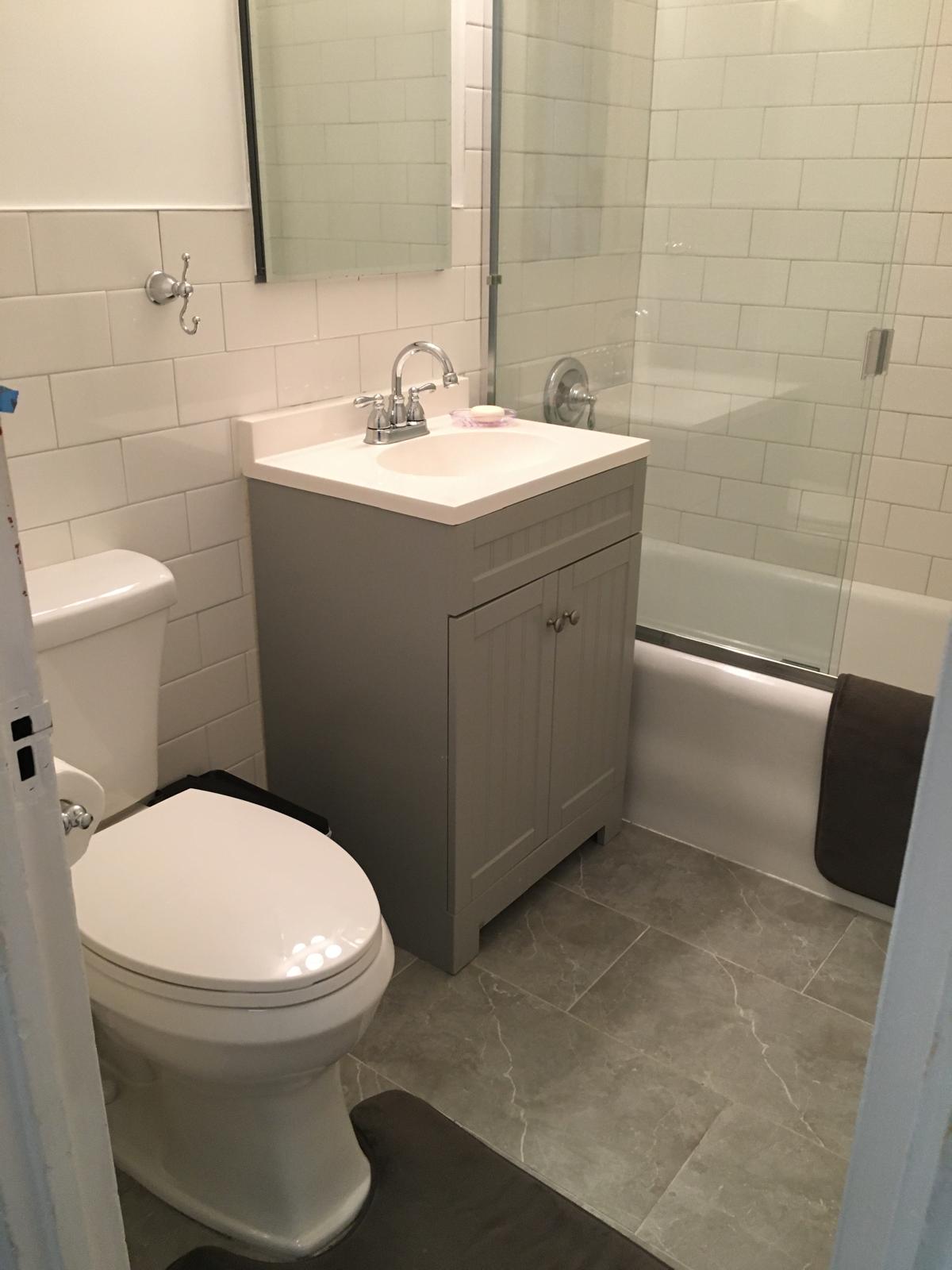 433 West 34th Street, Unit 7B Manhattan, NY 10001 - Photo 9 of 13 a bathroom with a toilet sink and mirror