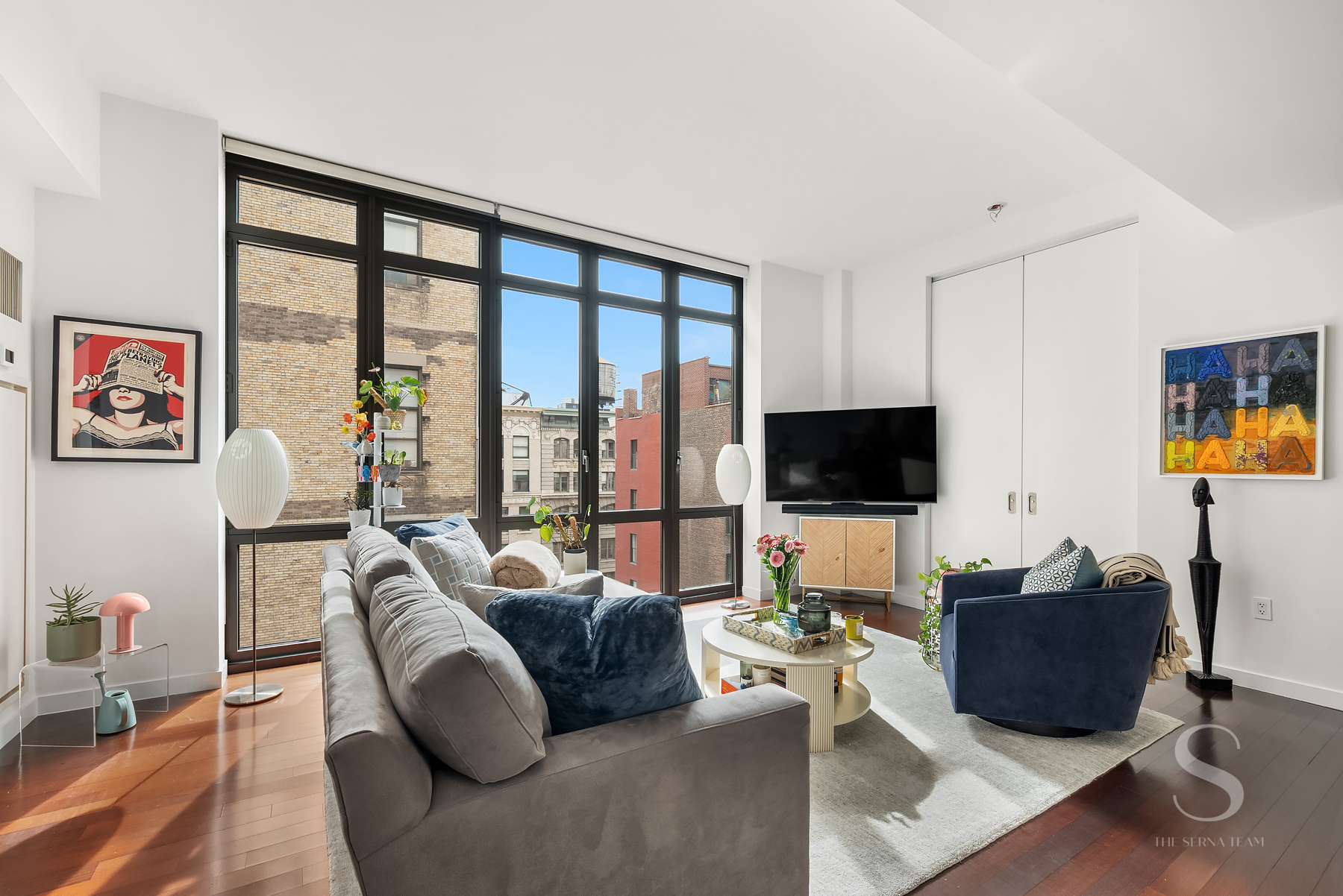 4 West 21st Street, Unit 14A Manhattan, NY 10010 - Photo 2 of 16 a living room with furniture and a flat screen tv