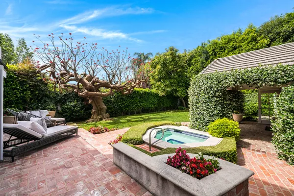 a view of a backyard with plants and outdoor seating