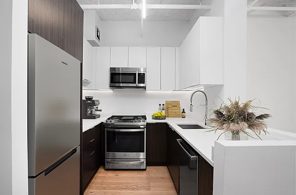 275 Park Avenue, Unit 2HH Brooklyn, NY 11205 - Photo 3 of 11 a kitchen with stainless steel appliances a sink cabinets and a refrigerator
