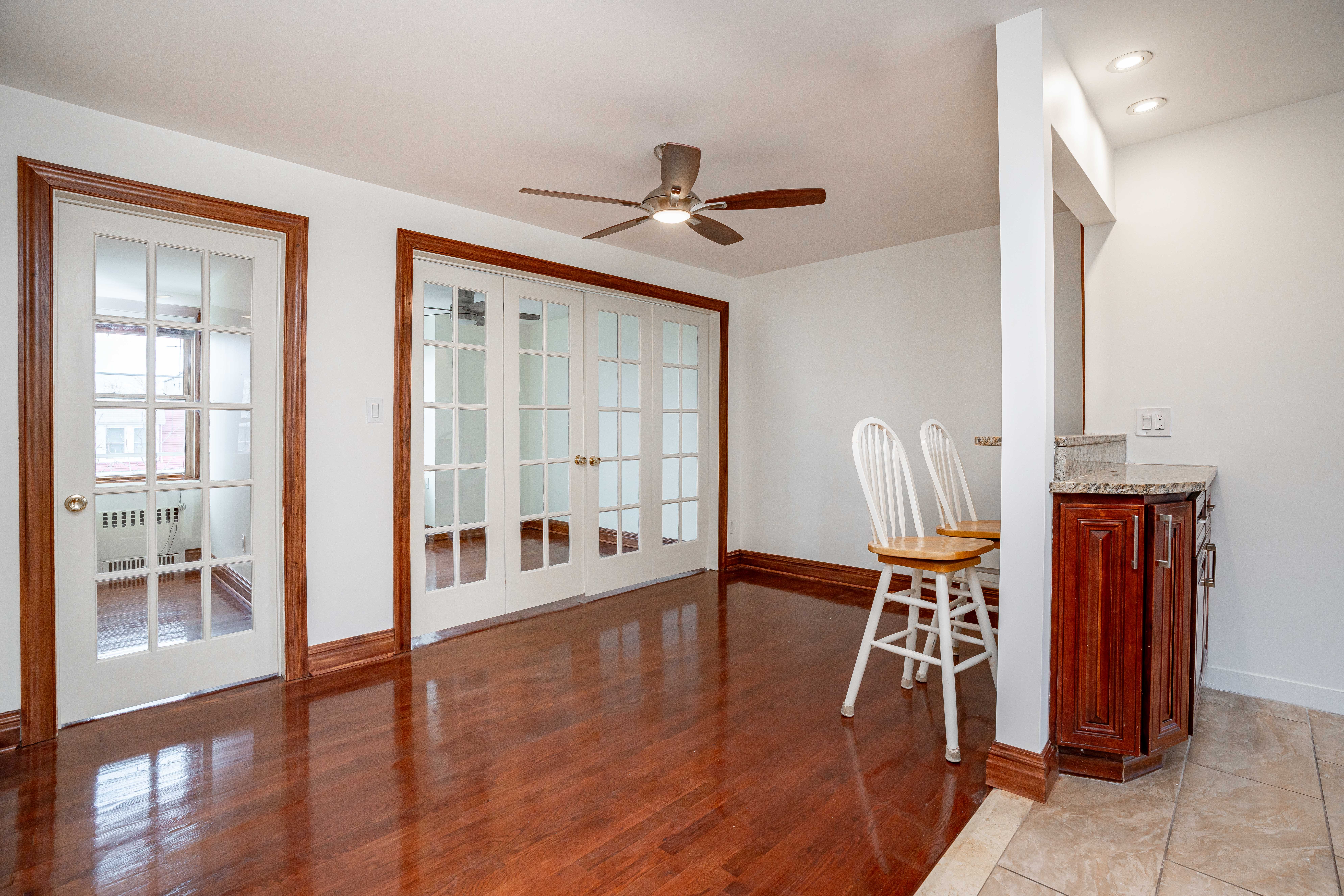 20-60 33rd Street, Unit 2 Queens, NY 11105 - Photo 1 of 10 a hallway with wooden floor windows and a chandelier