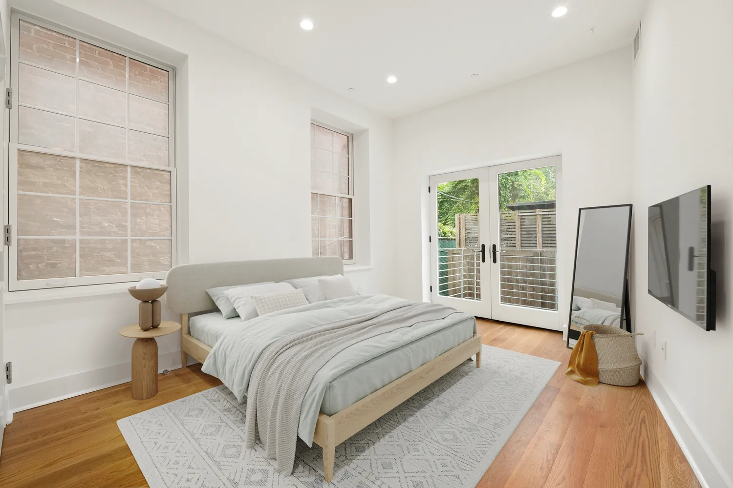 a spacious bedroom with a bed and a large window