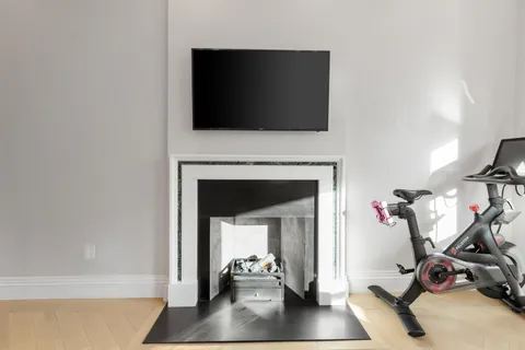 a view of a livingroom with a fireplace and a flat screen tv