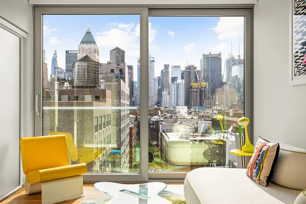 a living room with couches and a glass door with glass windows