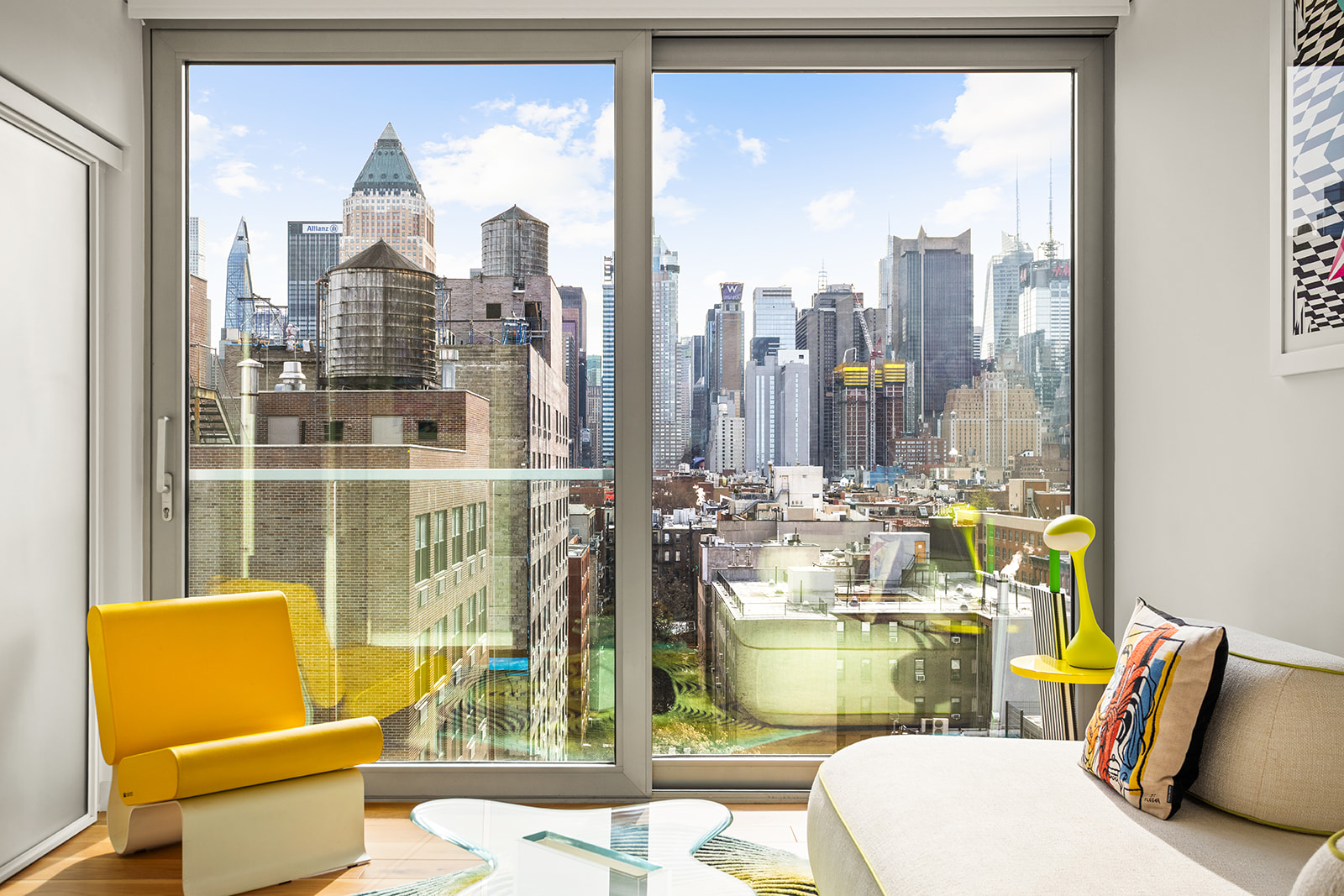 547 West 47th Street, Unit 1102 Manhattan, NY 10036 - Photo 2 of 19 a living room with couches and a glass door with glass windows